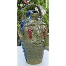 “Dripping Red Eyes Buggy” Face Jug